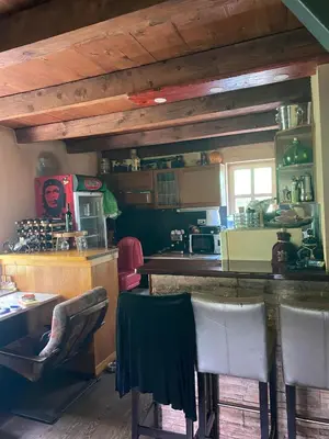 a kitchen with a counter and chairs in a room at Izletiste Pocivala in Podgorica