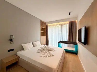 a bedroom with a bed with a flower on it at Two bedroom apartment Onia - Budva in Budva