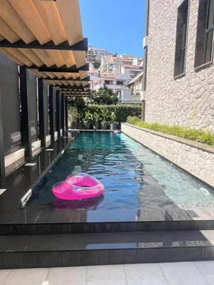 a swimming pool with a pink frisbee in the water at Two bedroom apartment Onia - Budva in Budva
