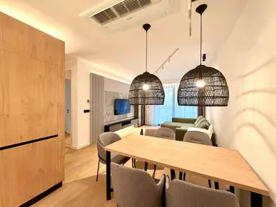 a dining room and living room with a table and chairs at Two bedroom apartment Onia - Budva in Budva