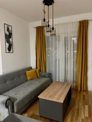a living room with a couch and a coffee table at Montenegro Suite Rental in Bar