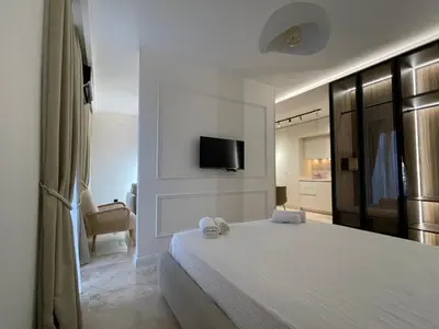 a bedroom with a bed and a tv on a wall at 13 July apartment in Budva