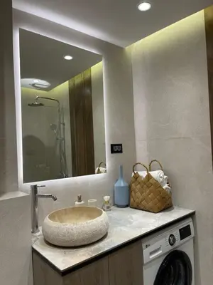 a bathroom with a sink and a mirror at 13 July apartment in Budva
