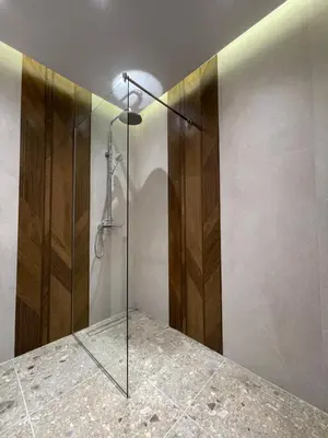 a shower with a glass door in a bathroom at 13 July apartment in Budva