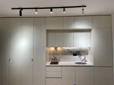 a kitchen with white cabinets and a sink at 13 July apartment in Budva