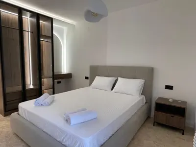 a bedroom with a white bed with two towels on it at 13 July apartment in Budva