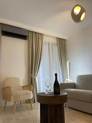 a living room with a couch and a table at 13 July apartment in Budva
