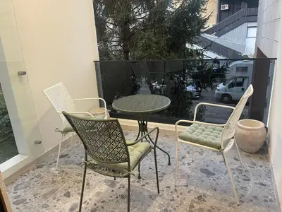 a patio with a table and chairs and a table and chairs at 13 July apartment in Budva