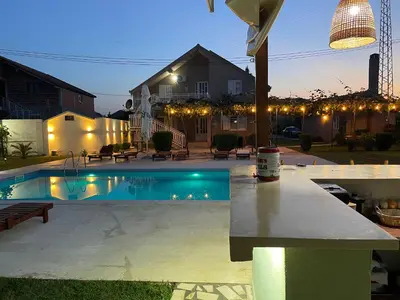 a backyard with a swimming pool at night at Stefhouse in Mojanovići