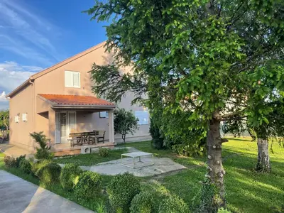 a house with a picnic table and a tree at Stefhouse in Mojanovići