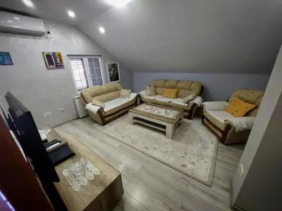 a living room with couches and a coffee table at Stefhouse in Mojanovići