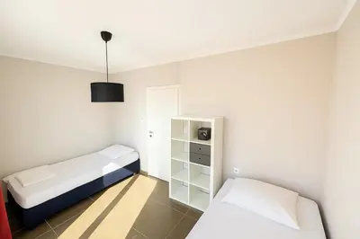 a small room with two beds and a cabinet at Million Star Villa in Lapčići