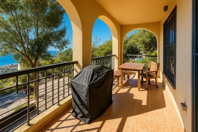 a balcony with a table and chairs and a view at Million Star Villa in Lapčići