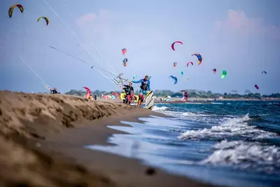 a group of people on the beach flying kites at Million Star Villa in Lapčići