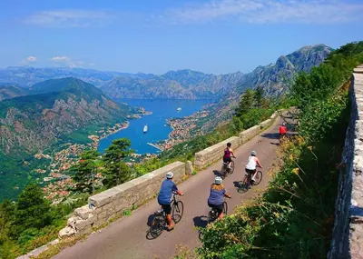 a group of people riding bikes down a mountain road at Million Star Villa in Lapčići