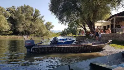 a group of boats are docked on a river at Million Star Villa in Lapčići
