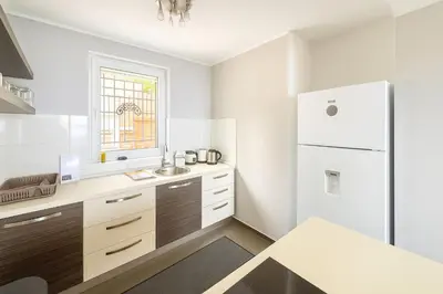a kitchen with a sink and a refrigerator at Million Star Villa in Lapčići