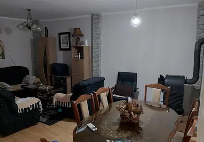 a living room with a table and chairs at Etno Selo - Familie Raickovic in Podgorica