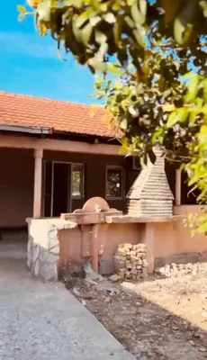 a house with a brick wall in front of it at Etno Selo - Familie Raickovic in Podgorica