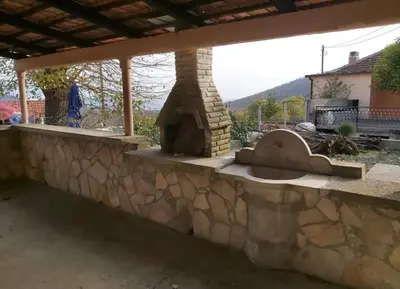 a stone wall with a stone oven in a yard at Etno Selo - Familie Raickovic in Podgorica