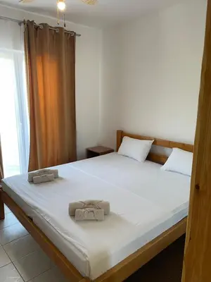 a bedroom with a large bed with towels on it at Konoba Ceklin in Cetinje