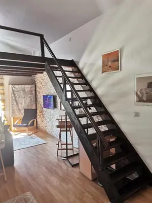 a spiral staircase in a room with a table at Gallery apartment Budva in Budva