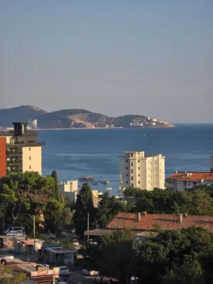 a view of a city with the ocean and buildings at Juzni Horizont Apartments in Sutomore