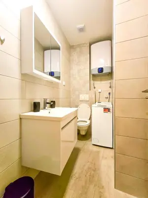 a small bathroom with a sink and a refrigerator at Juzni Horizont Apartments in Sutomore