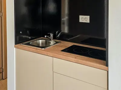 a kitchen with a sink and a stove at Juzni Horizont Apartments in Sutomore