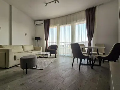 a living room with a couch and a table and chairs at Juzni Horizont Apartments in Sutomore