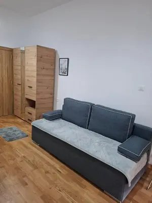 a large bed in a room with a wooden floor at Apartman One in Budva