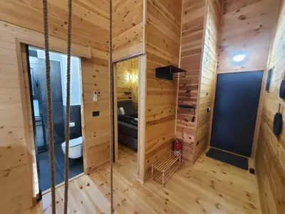 a room with wooden walls and wooden flooring at modernes Holzhaus, Cabin, auf dem Fluss, wenige Meter zum Meer in Ulcinj