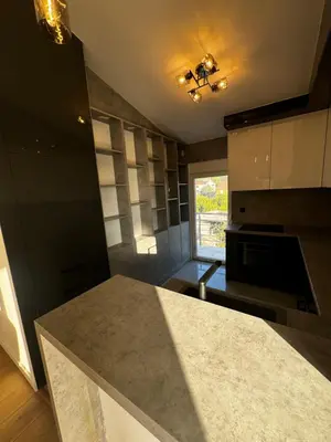 a kitchen with a granite counter top and a window at Čobrenović Penthouse in Bar