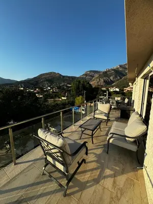 a group of chairs sitting on a balcony with a view at Čobrenović Penthouse in Bar