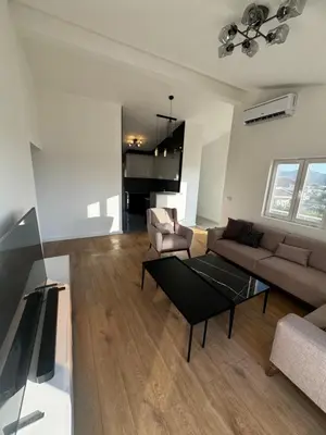 a living room with a couch and a coffee table at Čobrenović Penthouse in Bar