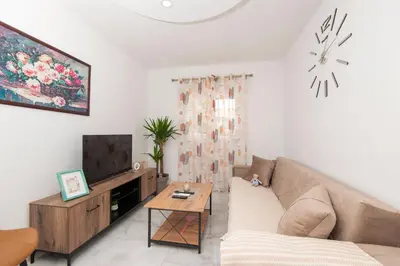 a living room with a couch and a tv at Apartmani Vesna in Radanovići