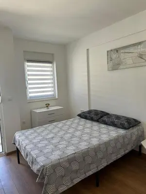 a bedroom with a large bed in a room at Appartement entièrement équipé neuf Budva - Appart 8 in Budva