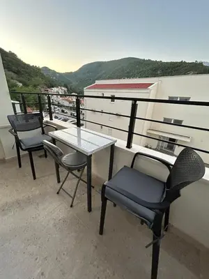 a table and chairs on a balcony with a view at Appartement entièrement équipé neuf Budva - Appart 8 in Budva