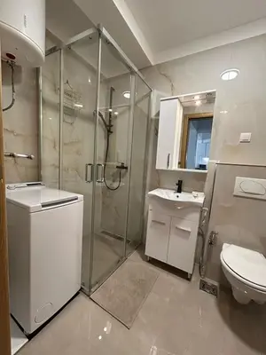 a bathroom with a shower and a toilet and a sink at Appartement entièrement équipé neuf Budva - Appart 8 in Budva