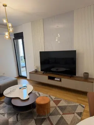 a living room with a large flat screen tv at Montenegro Luxury Suites - New City Podgorica in Podgorica