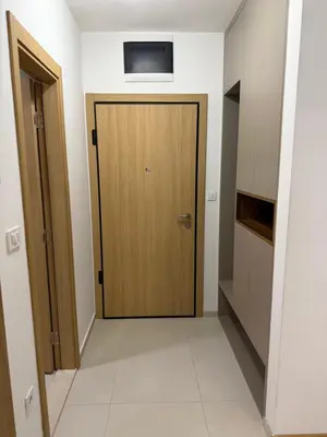 a hallway with a wooden door in a room at Montenegro Luxury Suites - New City Podgorica in Podgorica