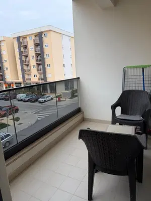 a balcony with a chair and a view of a city at Montenegro Luxury Suites - New City Podgorica in Podgorica