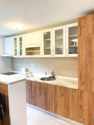 a kitchen with wooden cabinets and a sink at Tihanas apartment in Kotor