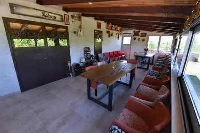 a dining room with a wooden table and chairs at Airport Apartments TRI HRASTA in Podgorica