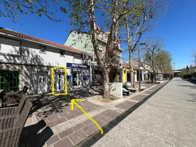 a street with a yellow arrow pointing to a building at Apartment 081 City Center in Podgorica
