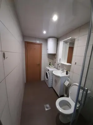 a small bathroom with a toilet and a sink at Apartment 081 City Center in Podgorica