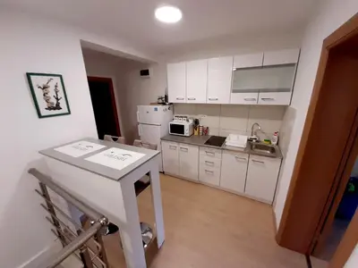a kitchen with white cabinets and a white counter top at Apartment 081 City Center in Podgorica