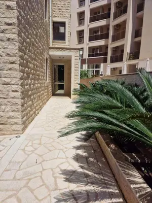 a walkway leading to a building with a building at Studio Apartment Ljilja in Budva