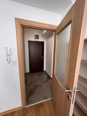 a door leading into a hallway with a hallway at Spring Apartment in Podgorica