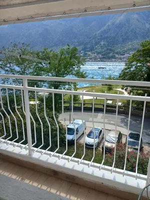 a balcony with cars parked in a parking lot at Apartment Icemoon in Kotor